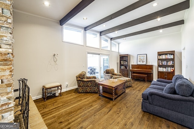 living room with vaulted ceiling with beams, crown molding, and dark wood-type flooring