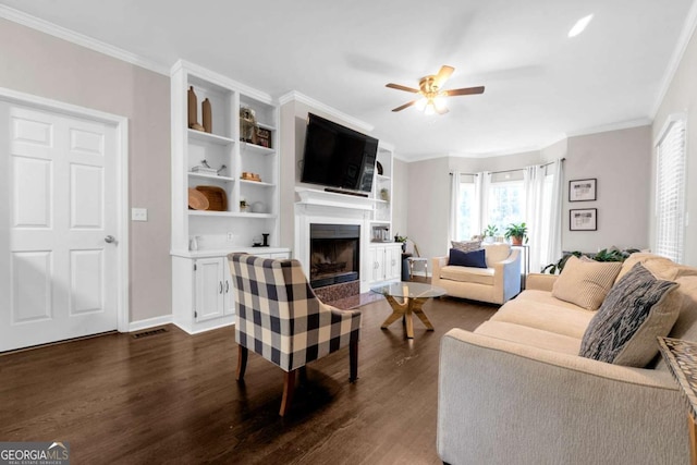 living room with dark hardwood / wood-style floors, ceiling fan, and crown molding