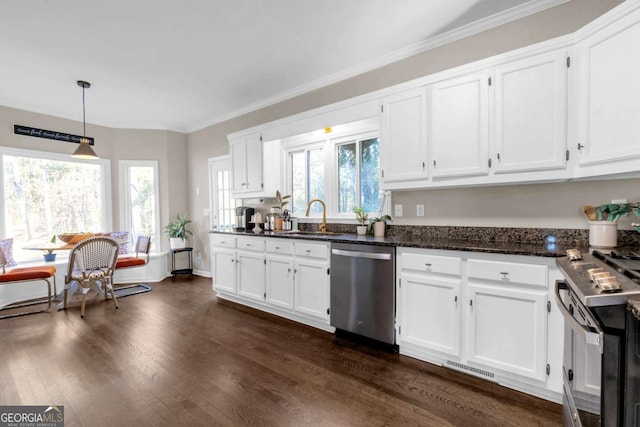 kitchen with white cabinetry, sink, a healthy amount of sunlight, stainless steel appliances, and pendant lighting