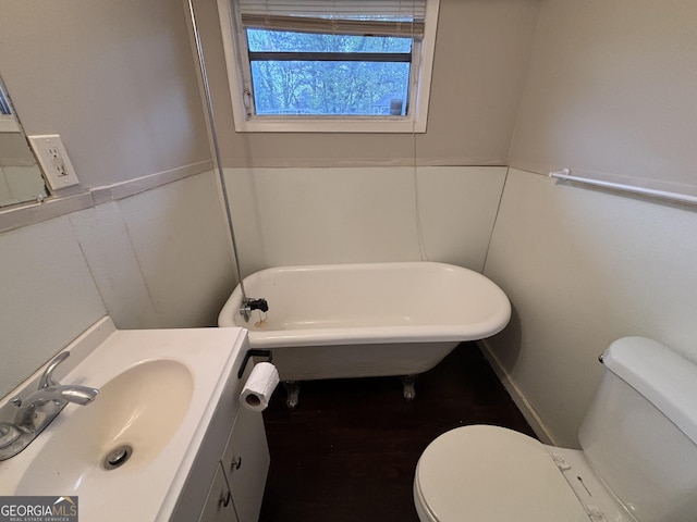 bathroom with vanity, a bathtub, and toilet