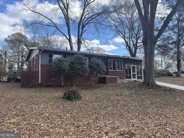 single story home featuring a sunroom