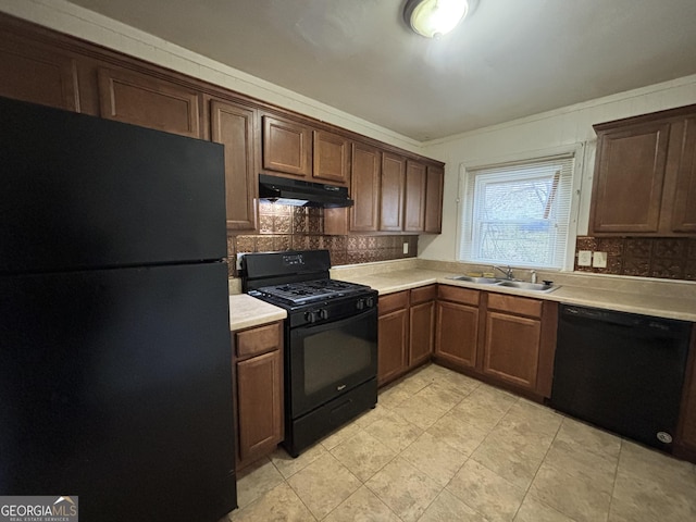 kitchen featuring tasteful backsplash, sink, crown molding, and black appliances