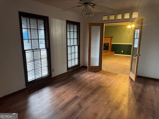 empty room with ceiling fan, a wealth of natural light, and french doors