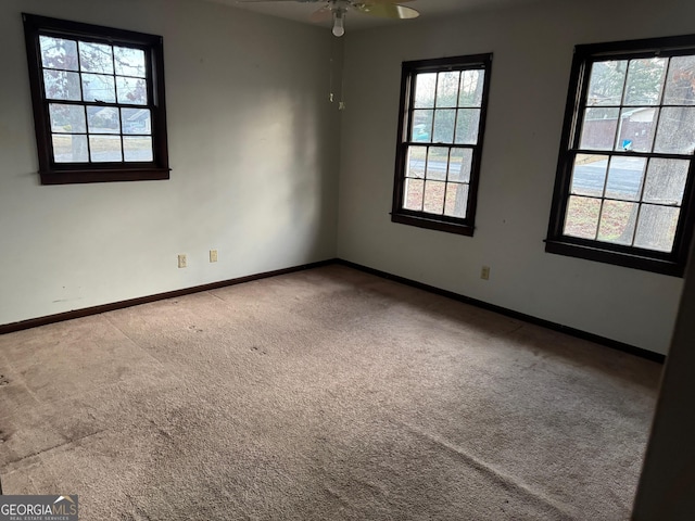 empty room featuring carpet flooring and ceiling fan