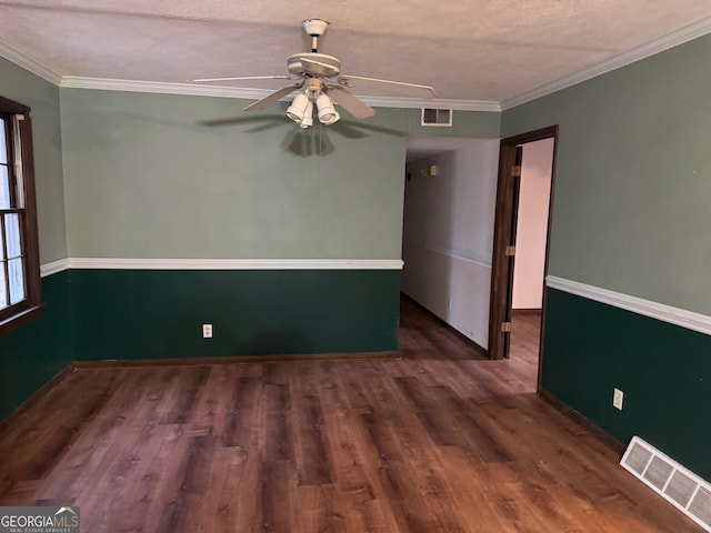 unfurnished room with dark hardwood / wood-style floors, ceiling fan, and crown molding