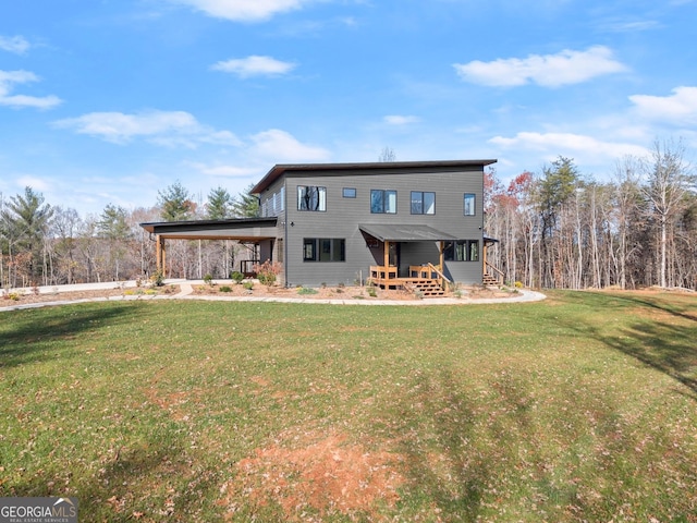 back of house with a lawn and a carport