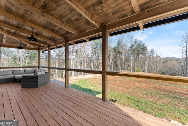 wooden deck featuring ceiling fan and outdoor lounge area