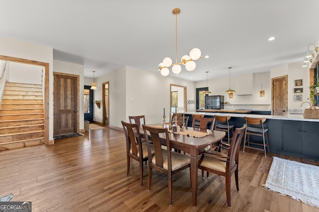 dining space with a chandelier and dark wood-type flooring