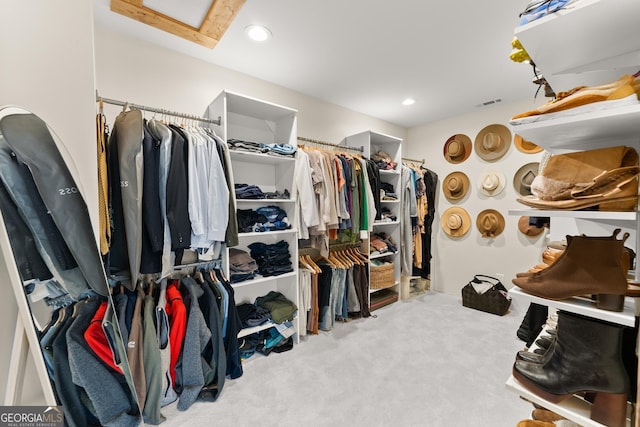 walk in closet featuring light carpet