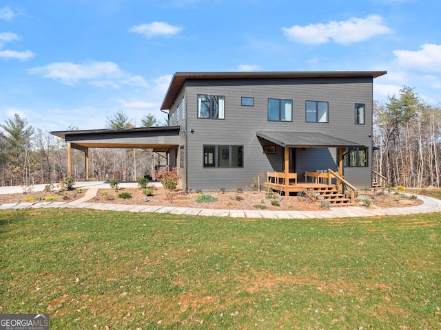 back of property with a carport and a yard