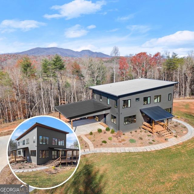 exterior space featuring a deck with mountain view and a lawn