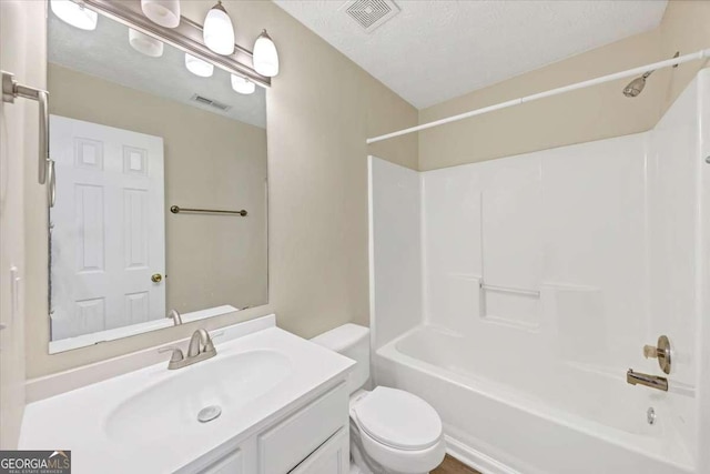 full bathroom featuring vanity, shower / tub combination, a textured ceiling, and toilet