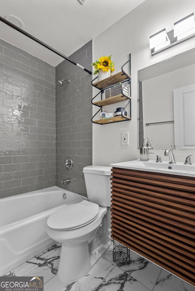 full bathroom with tiled shower / bath combo, toilet, and vanity