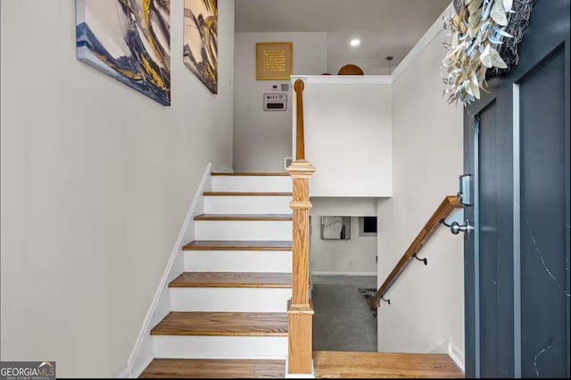 staircase with hardwood / wood-style floors