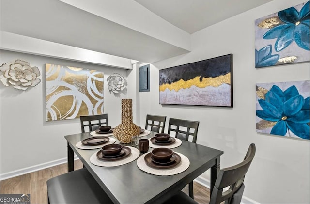 dining space with hardwood / wood-style floors