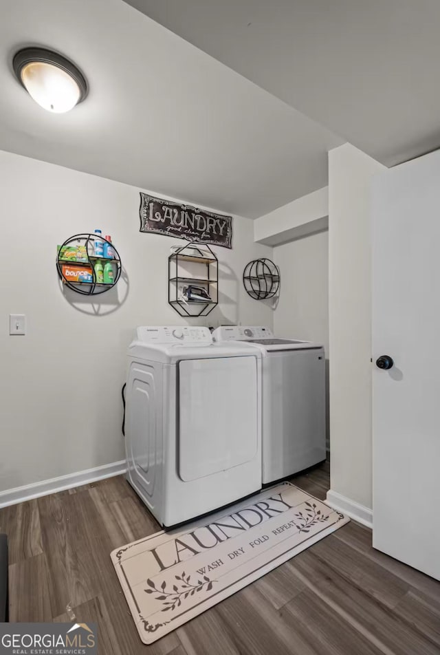 laundry area featuring separate washer and dryer and dark wood-type flooring