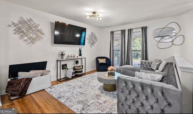 living room featuring hardwood / wood-style floors and an inviting chandelier