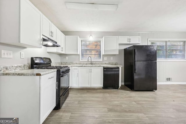 kitchen with black appliances, light hardwood / wood-style floors, white cabinetry, and sink