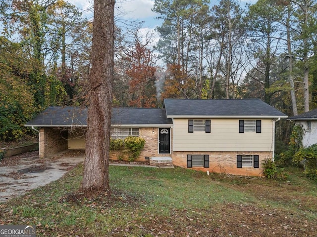 split level home with a front lawn and a carport