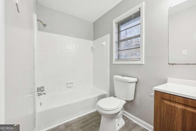 full bathroom featuring toilet, vanity,  shower combination, and hardwood / wood-style flooring