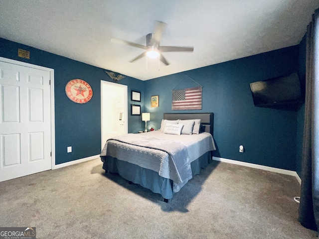 bedroom with carpet floors, ceiling fan, and baseboards