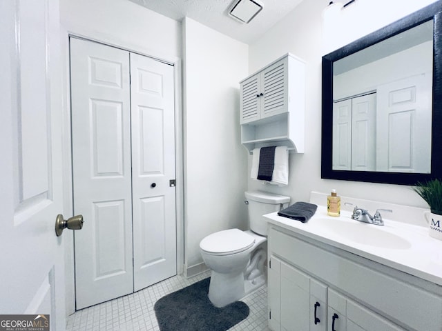 bathroom featuring tile patterned flooring, a closet, and toilet