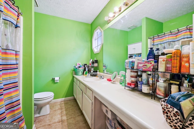 bathroom with walk in shower, vanity, a textured ceiling, and toilet