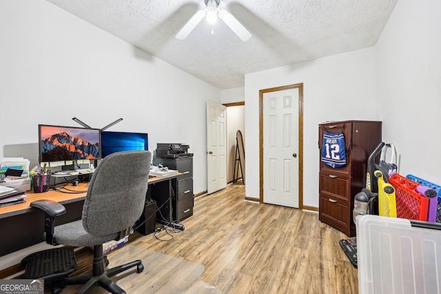 office space with ceiling fan, a textured ceiling, and light hardwood / wood-style flooring