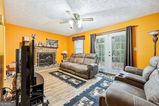 living room with french doors, a textured ceiling, and hardwood / wood-style flooring