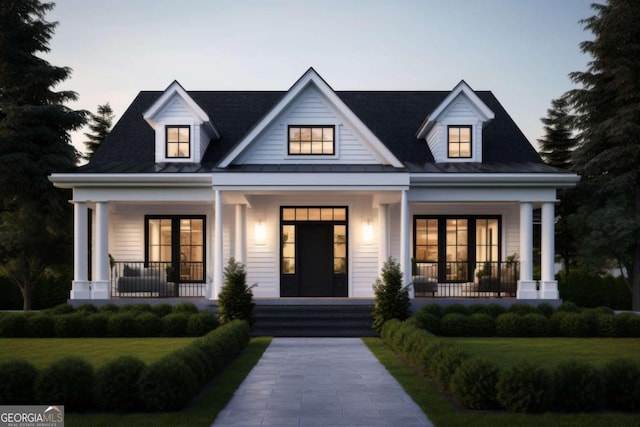 modern farmhouse featuring metal roof and covered porch