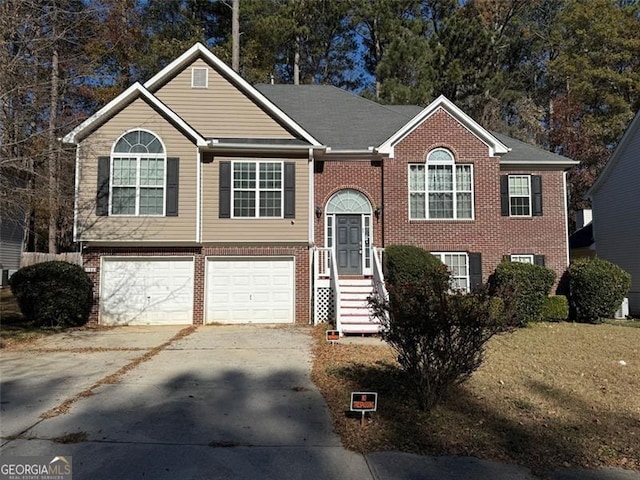 raised ranch with a garage and a front lawn