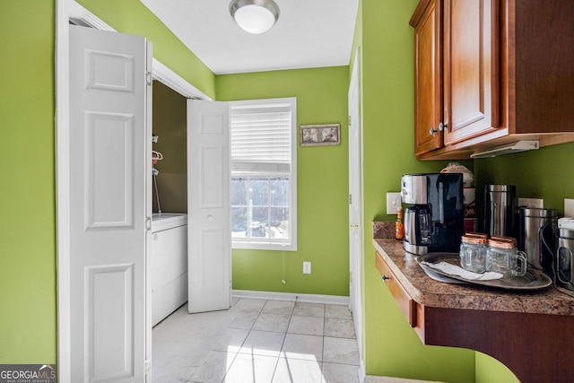 kitchen featuring washer / clothes dryer and light tile patterned flooring