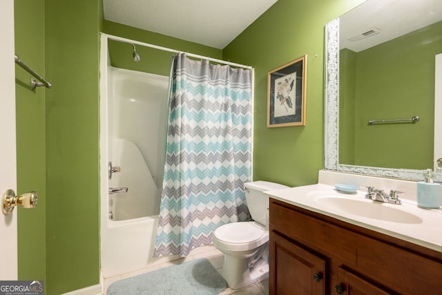 full bathroom featuring shower / bath combo, tile patterned floors, a textured ceiling, toilet, and vanity