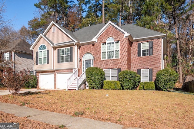 bi-level home with a garage and a front yard