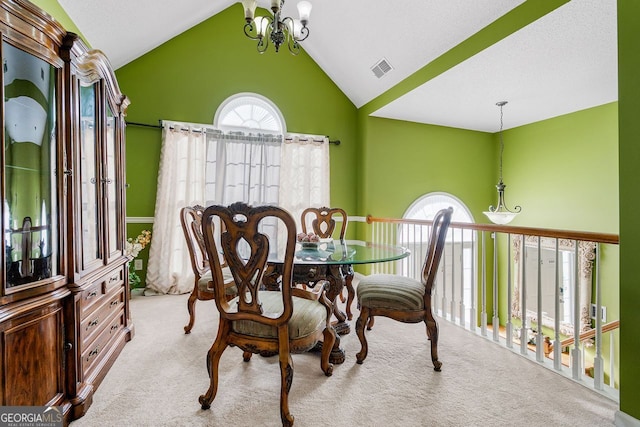 dining area with light carpet, a chandelier, and vaulted ceiling