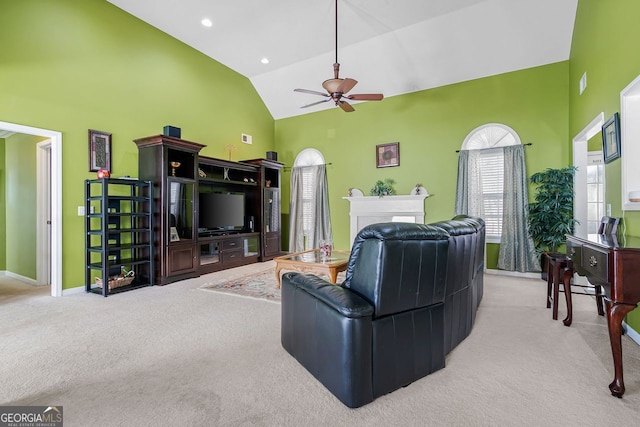 carpeted living room featuring high vaulted ceiling and ceiling fan