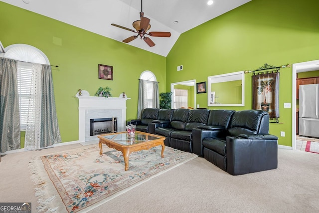 living room with ceiling fan, carpet, and high vaulted ceiling