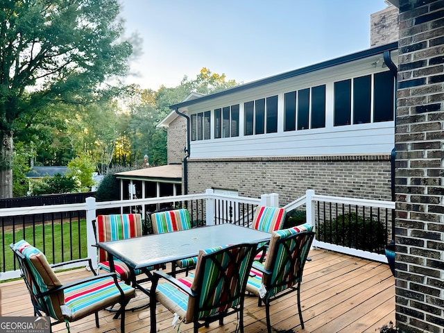 wooden terrace featuring a yard