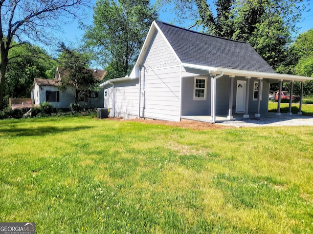 exterior space with central AC and a front lawn