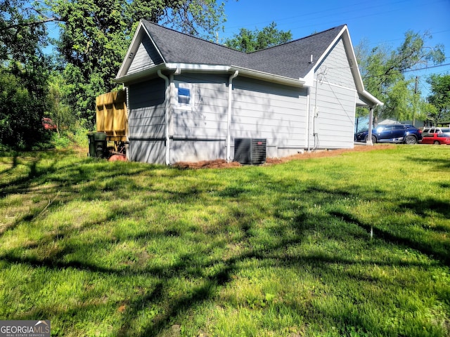 view of home's exterior with a yard and central air condition unit