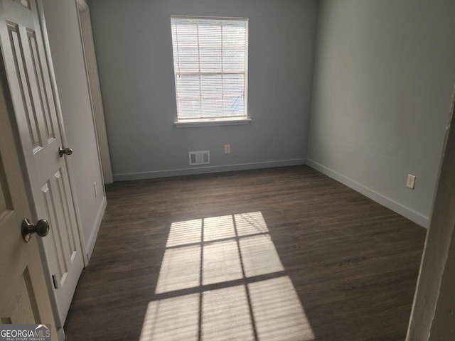 spare room featuring dark hardwood / wood-style flooring