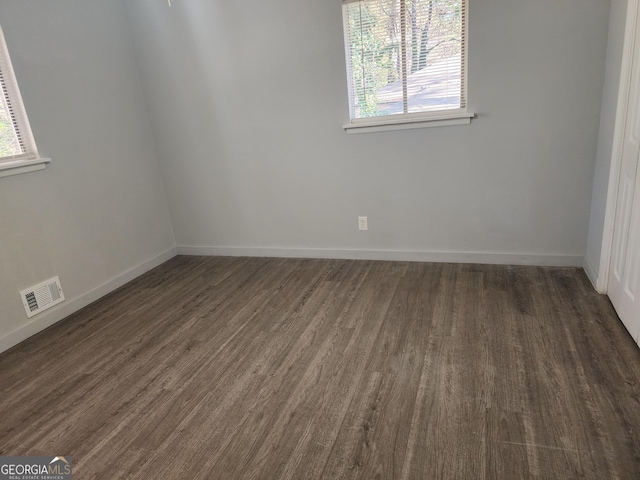 spare room featuring dark wood-type flooring