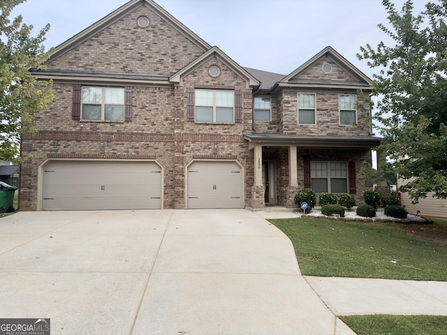 view of front of property with a front lawn and a garage