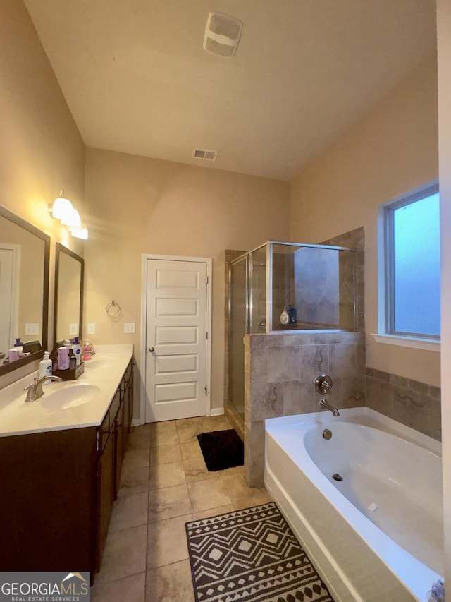 bathroom featuring tile patterned flooring, shower with separate bathtub, and vanity