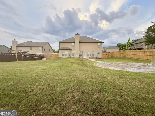 rear view of property featuring a lawn