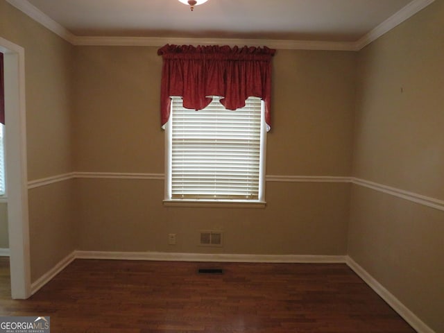 spare room featuring crown molding and dark hardwood / wood-style flooring