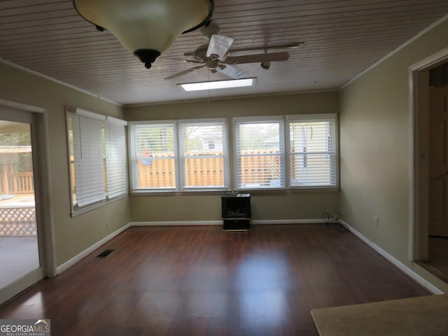 unfurnished sunroom featuring wooden ceiling, ceiling fan, and a healthy amount of sunlight