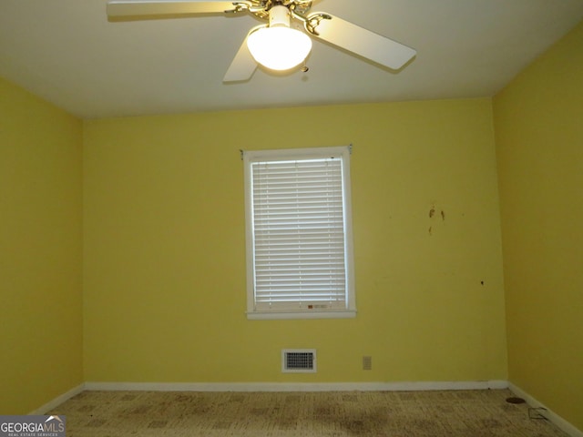 carpeted empty room featuring ceiling fan