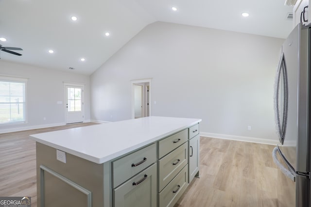 5704 Payton Pl, Lake Park, GA 31636 - kitchen with freestanding refrigerator, light wood-style flooring, light countertops, and a center island