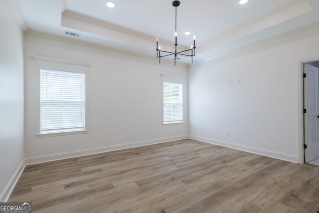 5704 Payton Pl, Lake Park, GA 31636 - unfurnished room featuring light wood-style flooring, a notable chandelier, a tray ceiling, and crown molding